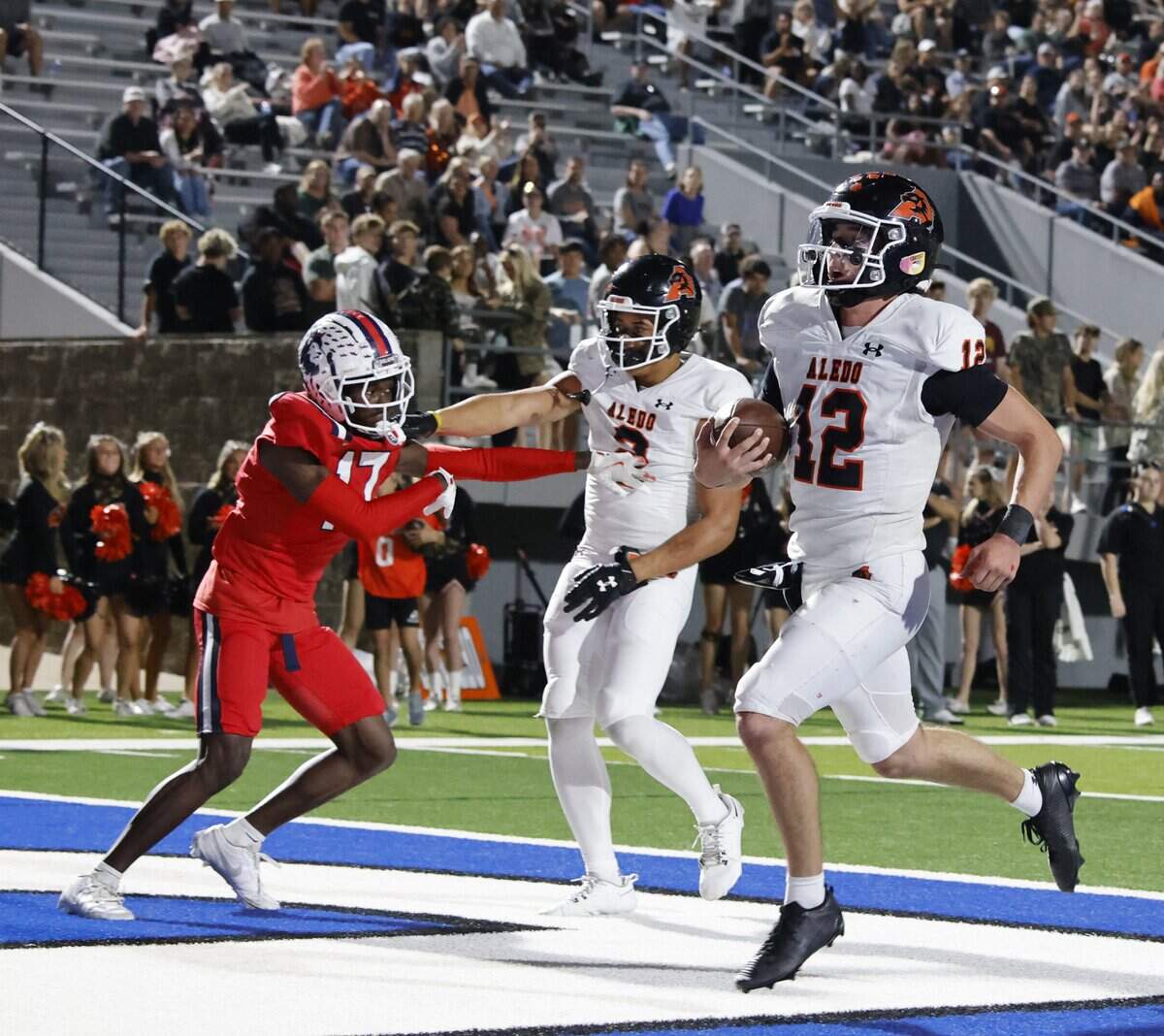Aledo quarterback Lincoln Tubbs (12) crosses the goal line for six during the first half of a UIL football game against North Richland Hills Richland on Thursday, October, 23, 2025 at Birdville FAAC Stadium in North Richland Hills, Texas.