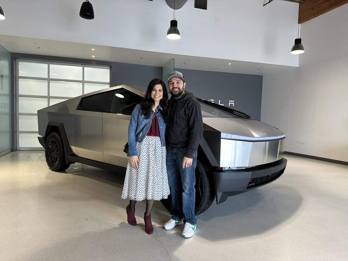 A photo of Michelle Abner and her husband, Cody, picking up their Cybertruck.
