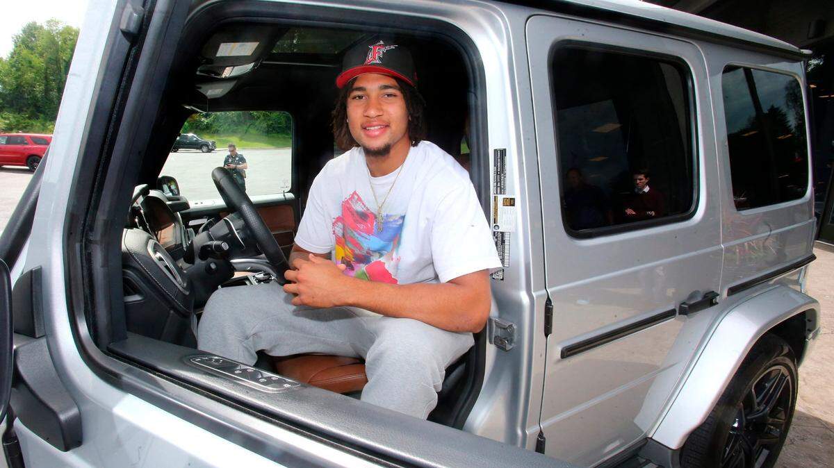 Ohio State quarterback C.J. Stroud sits in the drivers seat after he received a 2019 Mercedes G-Wagon G63 in Canton, Ohio on June 8, 2022. Stroud has a deal with Sarchione Auto Gallery that allows them to use the quarterback’s name, image and likeness in its advertising.