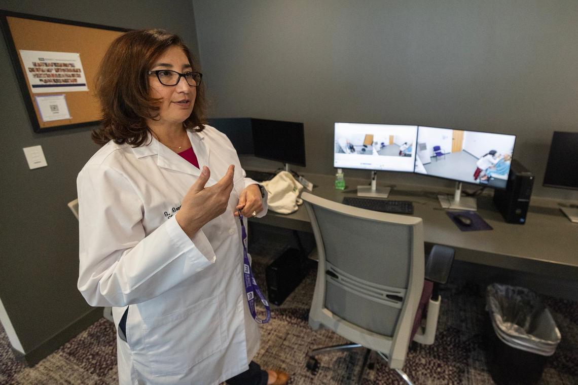 Sandra Esparza, the Assistant Dean of Clinical Curriculum, watches the cameras and listens to the microphone in the exam room during a “patient encounter” session in an exam room in the Clinical Skills Area at the TCU Burnett School of Medicine in Fort Worth on Tuesday, Sept. 17, 2024.