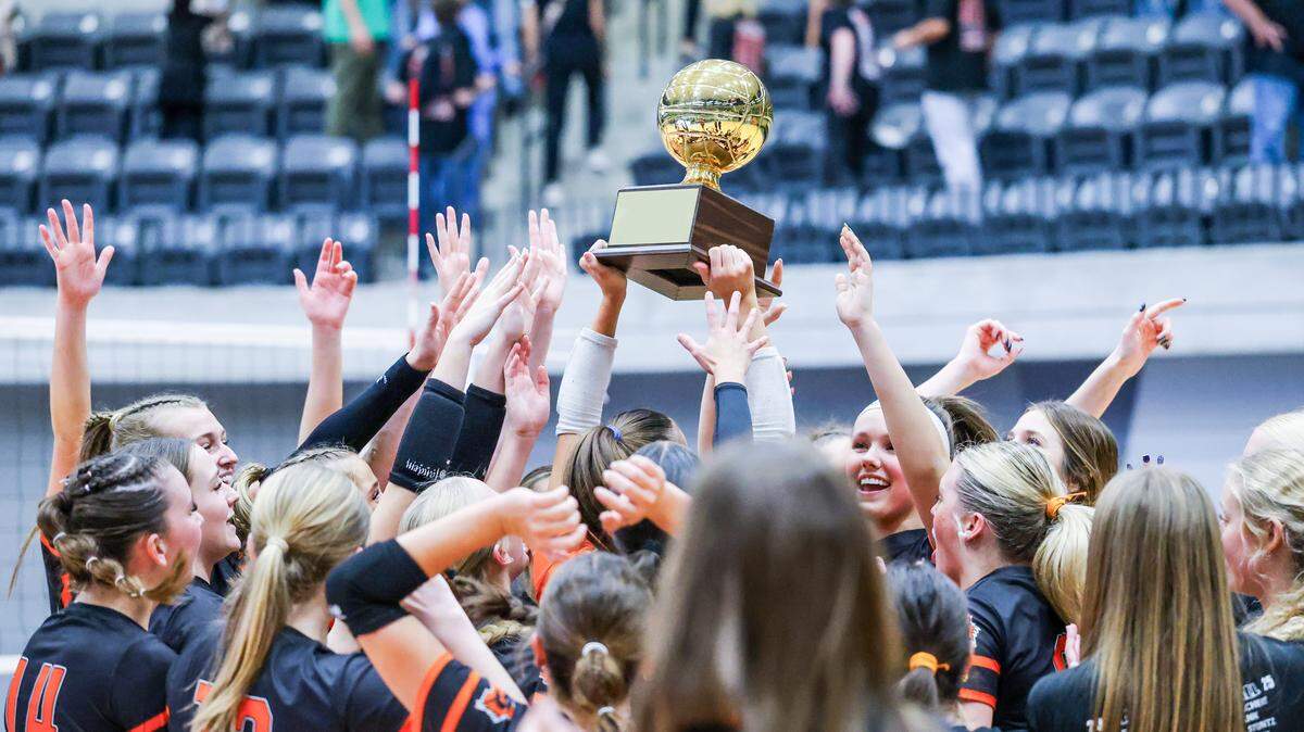 Aledo players hoist the trophy after a bi-district playoff victory over Colleyville Heritage on Thursday at Arlington ISD Athletics Center.