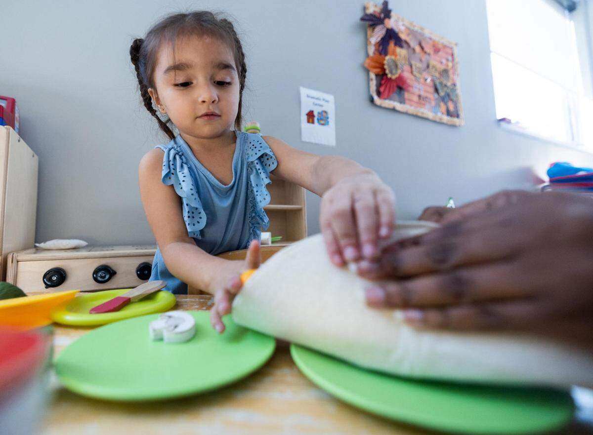 AmandaLyn Rodriguez, 3, plays with a teacher at Annie’s Place in October. Her mother, Alexandrea Ruiz, uses the free child care at Annie’s Place so she can get treatment for an advanced stage of cervical cancer at Parkland Memorial Hospital in Dallas.