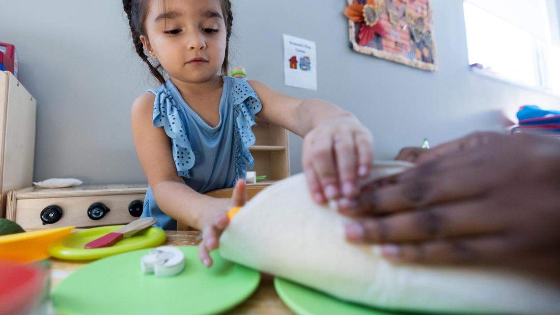 AmandaLyn Rodriguez plays with a teacher at Annie’s Place in Dallas in October 2022. AmandaLyn, her sister, and her mom were enrolled in Medicaid health insurance throughout the course of the COVID-19 pandemic.