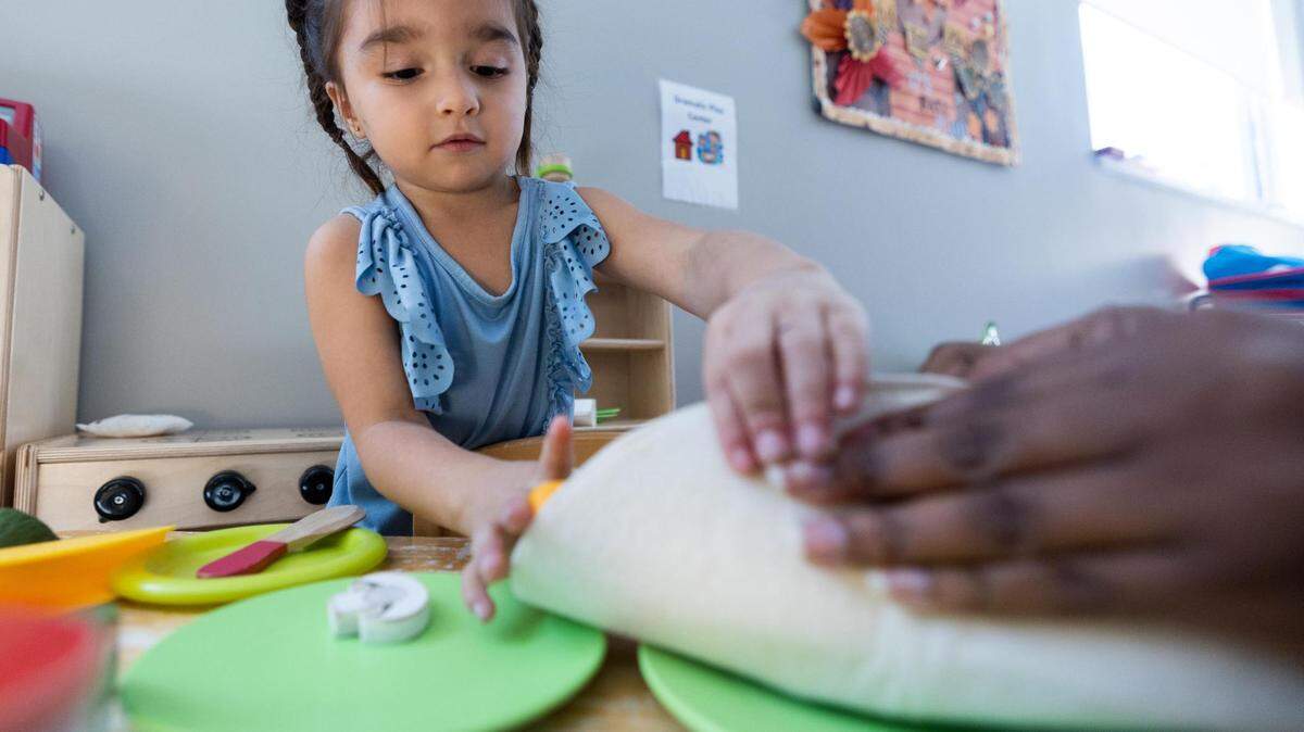 AmandaLyn Rodriguez plays with a teacher at Annie’s Place in Dallas in October 2022. AmandaLyn, her sister, and her mom were enrolled in Medicaid health insurance throughout the course of the COVID-19 pandemic.