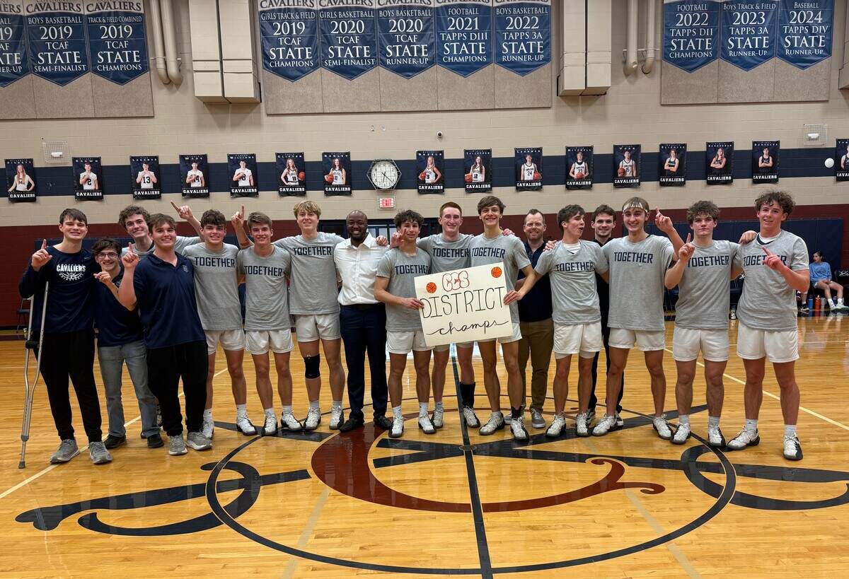The Fort Worth Covenant Classical basketball team poses after defeating Kennedale Fellowship to go undefeated and win the TAPPS District 1-3A title.