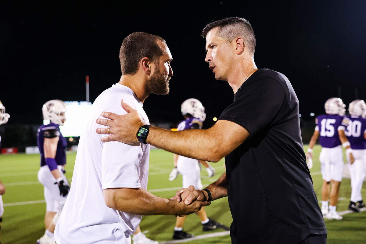 Southlake Carroll head coach Riley Dodge, right, shakes hands with Keller Timber Creek head coach Austin Kaehn, left, following a 55-13 win by Carroll on Thursday, September 25, 2025 at Keller ISD Stadium in Keller, Texas.