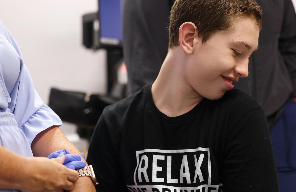 Preston Benjaman-Sewell smiles while holding his mother’s arm at an appointment at Cook Children’s Dodson Specialty Clinics on June 24.
