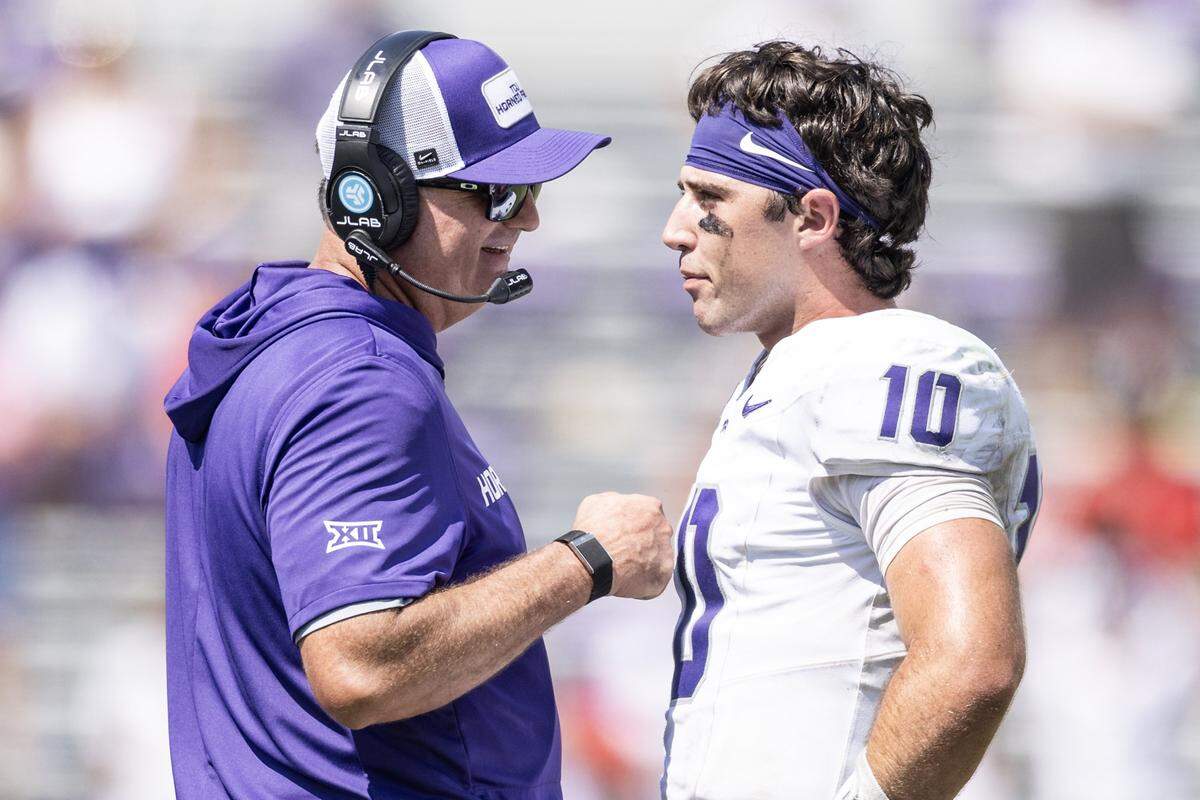 TCU head coach Sonny Dykes shares a laugh with quarterback Josh Hoover (10) in the second half of an NCAA football game between TCU and SMU at Amon G. Carter Stadium in Fort Worth on Saturday, Sept. 20, 2025. TCU won 35-24 in the final Iron Skillet Rivalry game.