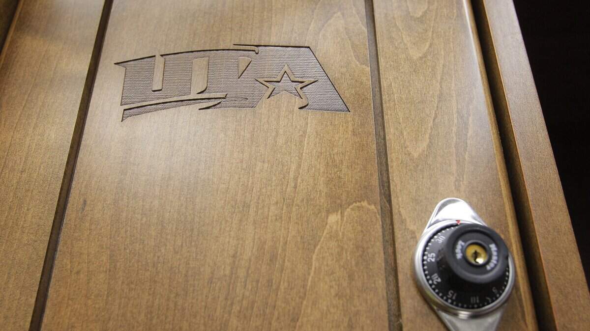 The UTA logo is engraved in the wood locker door in one of the home team dressing rooms in 2011.