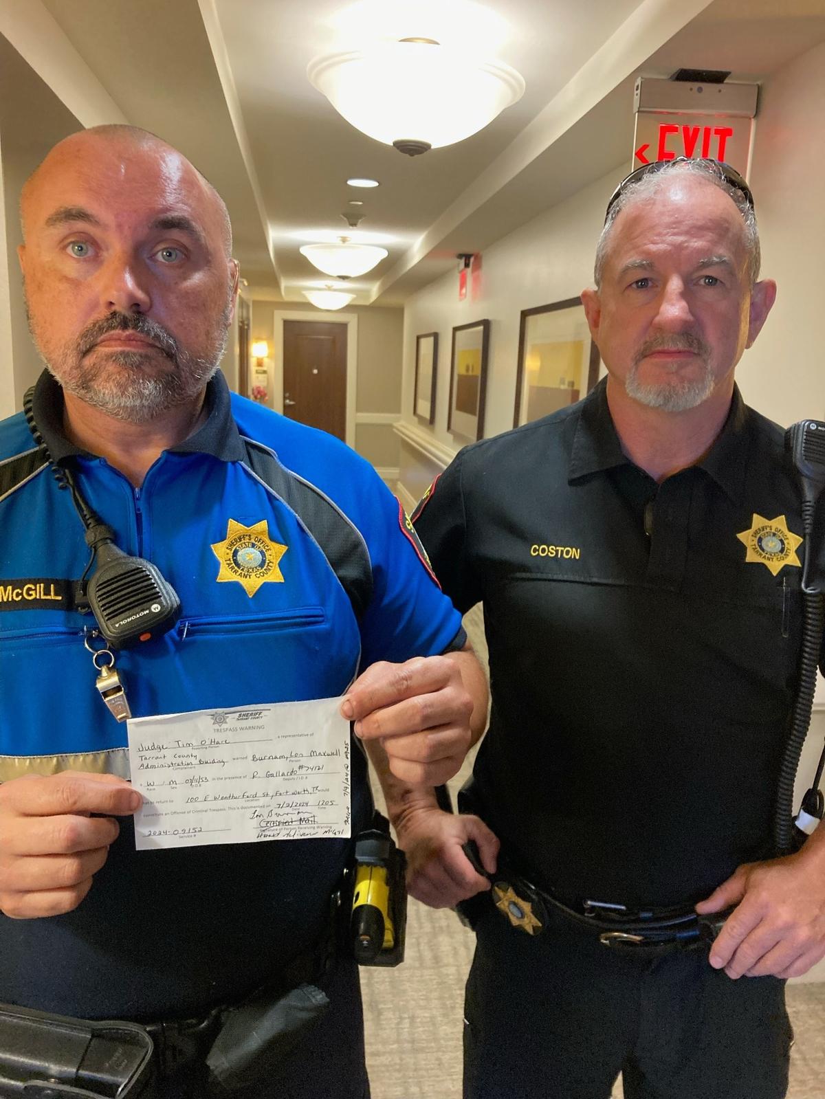 Two Tarrant County Sheriff’s office employee’s presenting a trespassing warning to Former state Rep. Lon Burnam, D-Fort Worth at his residence on July 9, 2024.