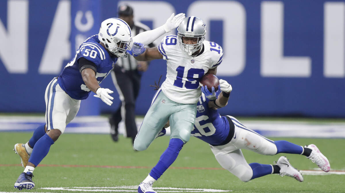 Dallas Cowboys wide receiver Amari Cooper (19) is tackled by Indianapolis Colts’ Anthony Walker (50) and Clayton Geathers (26) during the first half of an NFL football game, Sunday, Dec. 16, 2018, in Indianapolis.