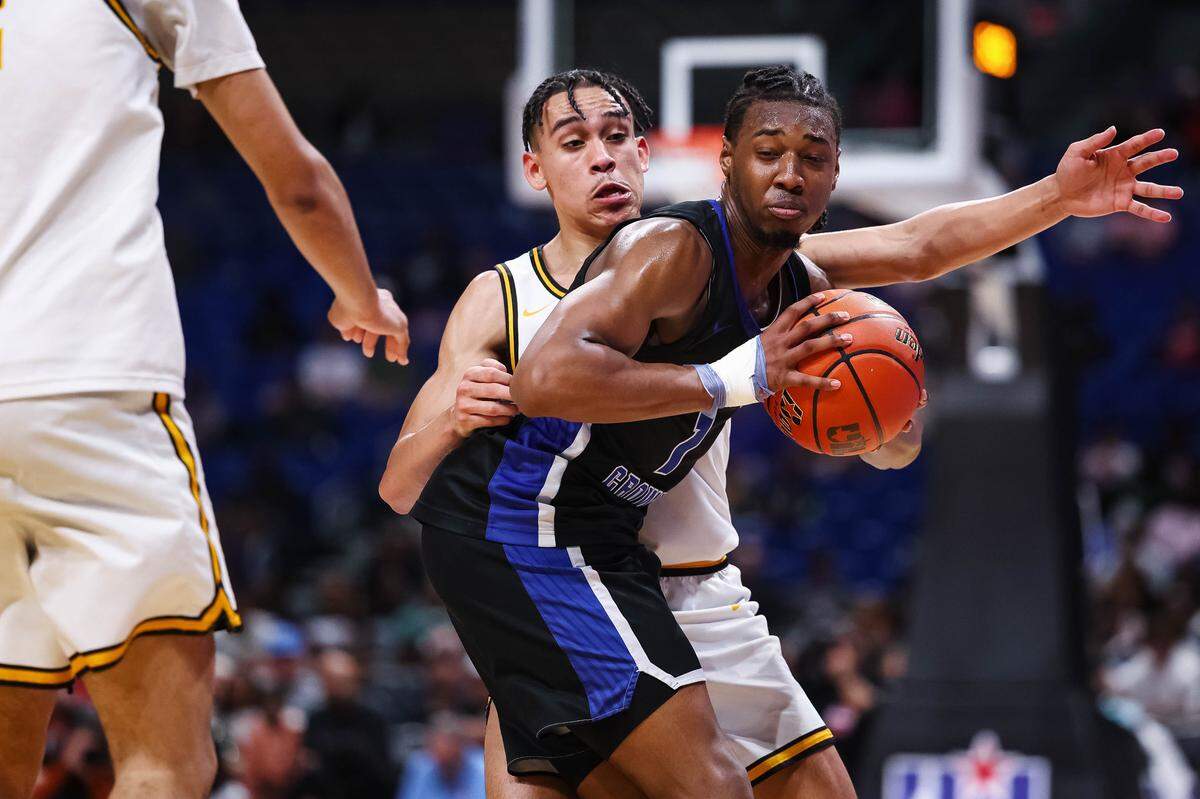 North Crowley forward Alex Barther II holds the ball while being tightly defended by a San Antonio Brennan player in the Class 6A Division I state championship game Saturday at the Alamodome in San Antonio.