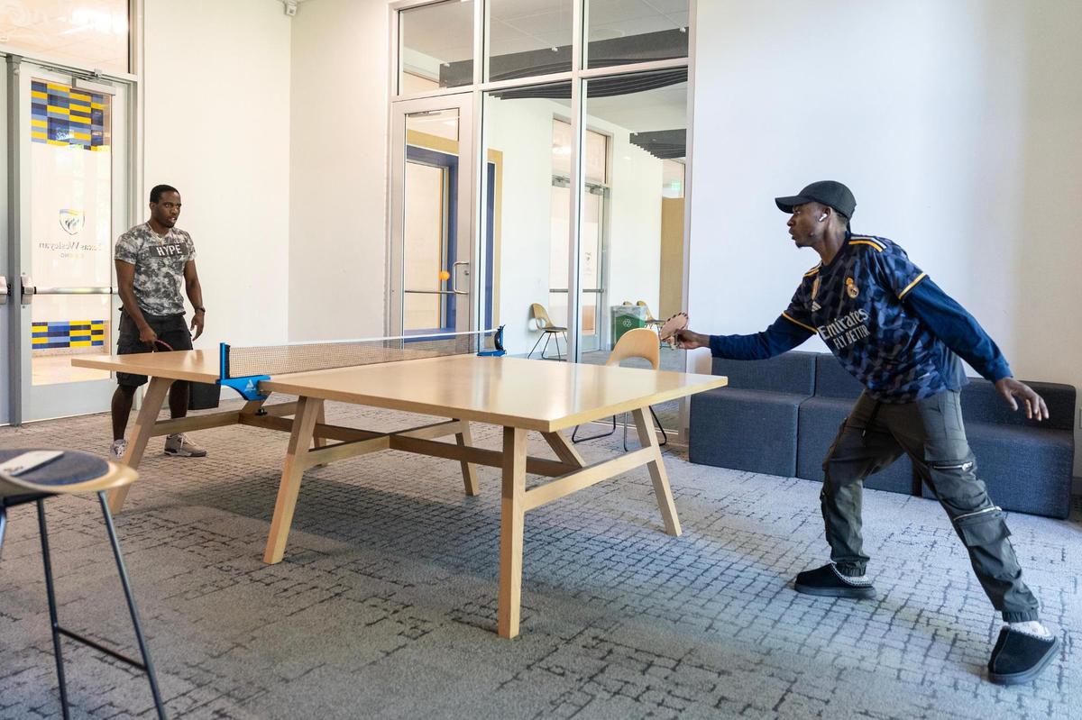 Junior Cephas Olufade, left, plays table tennis with Daniel Adegoke in the game room at the Nick and Lou Martin University Center on campus on Tuesday, April 8, 2025.