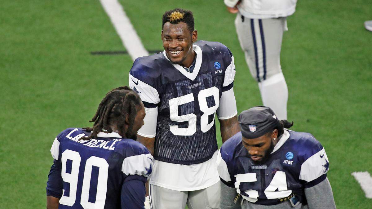 Dallas Cowboys defensive end Aldon Smith talks with DeMarcus Lawrence, left, and Jaylon Smith during training camp Thursday at The Star in Frisco.