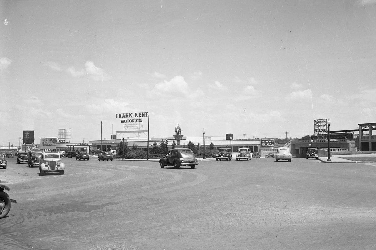 Frank Kent Motor Company, originally a Ford dealership that became a Cadillac dealership in 1953, opened on the site of the old T&P passenger station in late 1939. The Al Hayne monument is in the foreground.