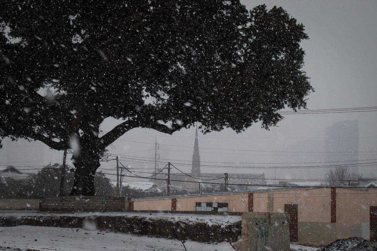 Downtown is obscured as snow continues to fall in Near Southside Thursday, Feb. 3, 2022, in Fort Worth.