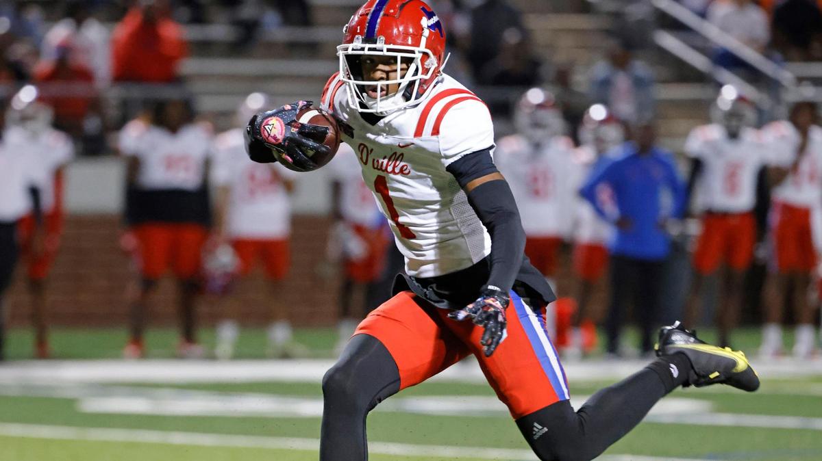 Duncanville wide receiver Dakorien Moore (1) steps over Mansfield defender David Hogg (9) on the way to the end zone in the first half of a UIL high school football game at Vernon Newsom Stadium in Mansfield, Texas, Thursday, Oct. 12, 2023.