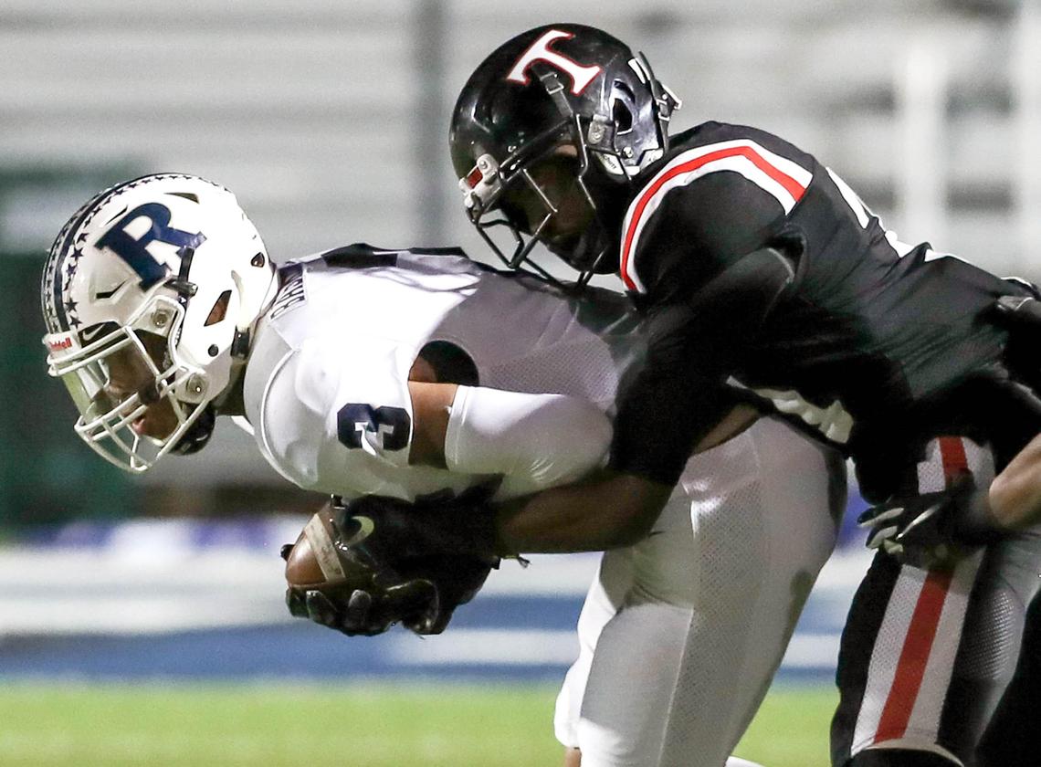 Richland wide receiver C.J. Baskerville (3) comes up with a reception and is brought down by Euless Trinity defensive back Micah Woodley (R) during the first half, Friday night, November 8 2019 played at Pennington Field in Bedford, TX.