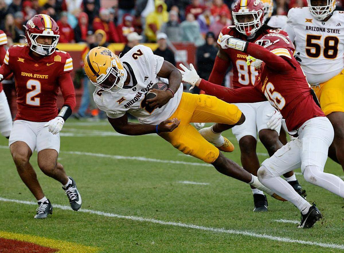 AMES, IOWA - NOVEMBER 1: Quarterback Jeff Sims #2 of the Arizona State Sun Devils dives into the end zone for a touchdown as defensive back Jamison Patton #2, tight end Tripp Walsh #86, and defensive back Carson van Dinter #36 of the Iowa State Cyclones defend in the first half of play at Jack Trice Stadium on November 1, 2025, in Ames, Iowa. (Photo by David Purdy/Getty Images)