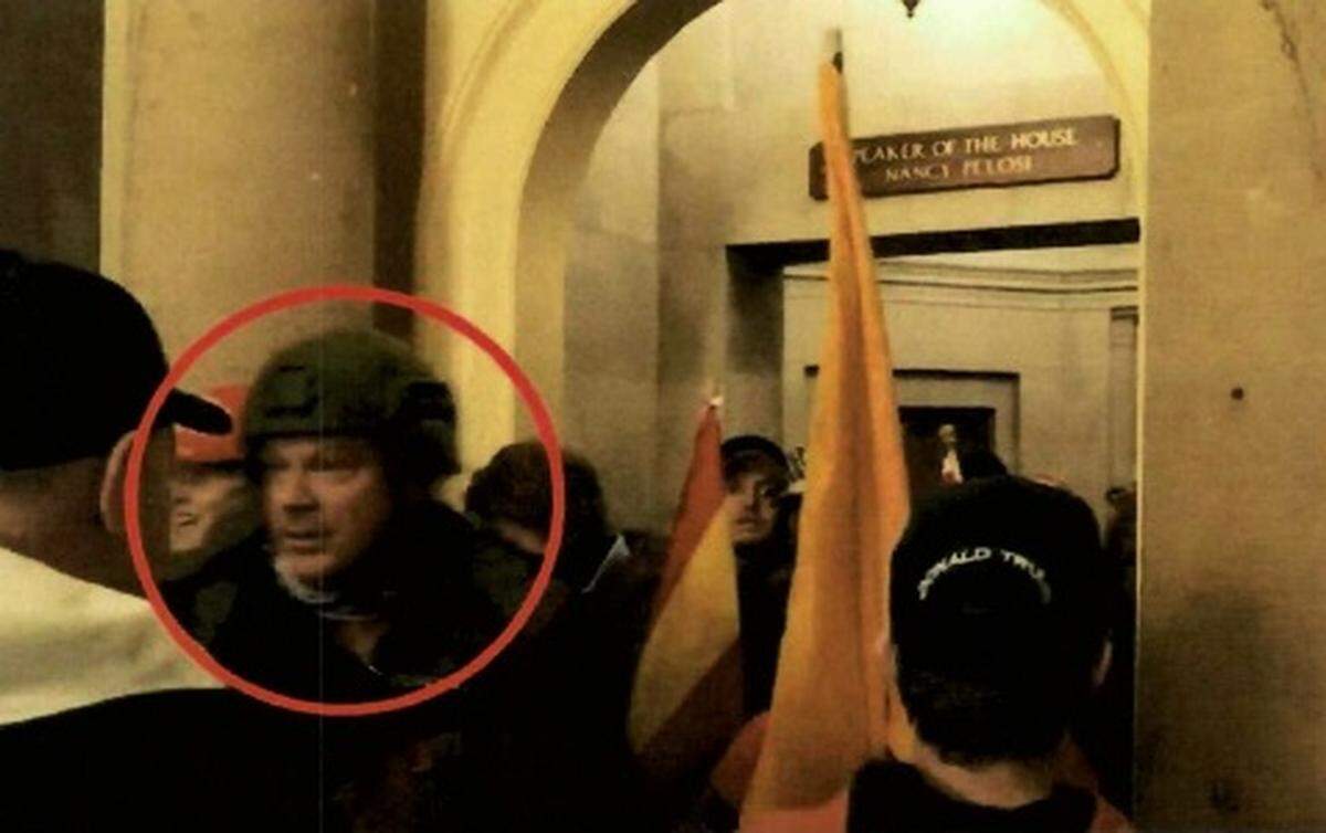 The photograph shows Larry Brock Jr. of Grapevine, Texas outside of the office of House Speaker Nancy Pelosi on Jan. 6, 2021.