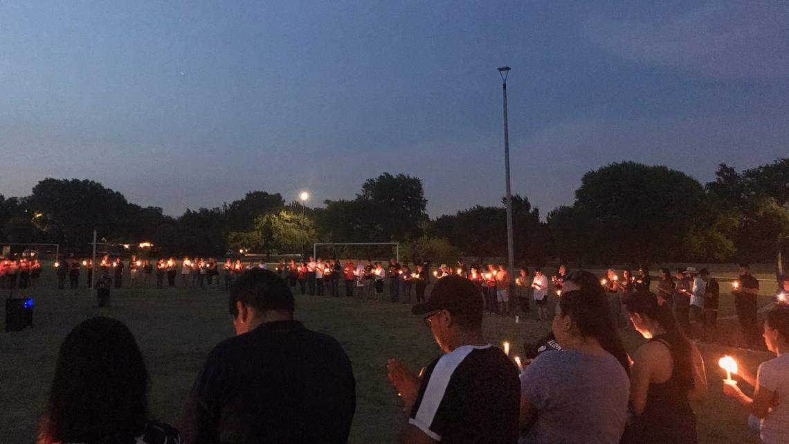People attending Wednesday night’s candlelight vigil at Unity Park in Fort Worth show their respect to the El Paso and Dayton, Ohio shooting victims.