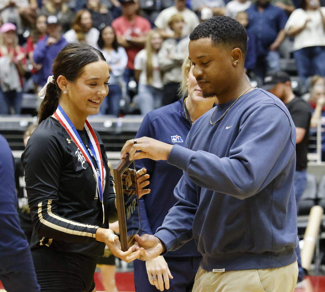 Fort Worth Eagle Mountain setter Molly Aubert (13) receives the MVP trophy after winning the UIL Class 4A Division II state volleyball championship game against Wimberley Friday Nov. 21, 2025 at Curtis Culwell Center in Garland, Texas.