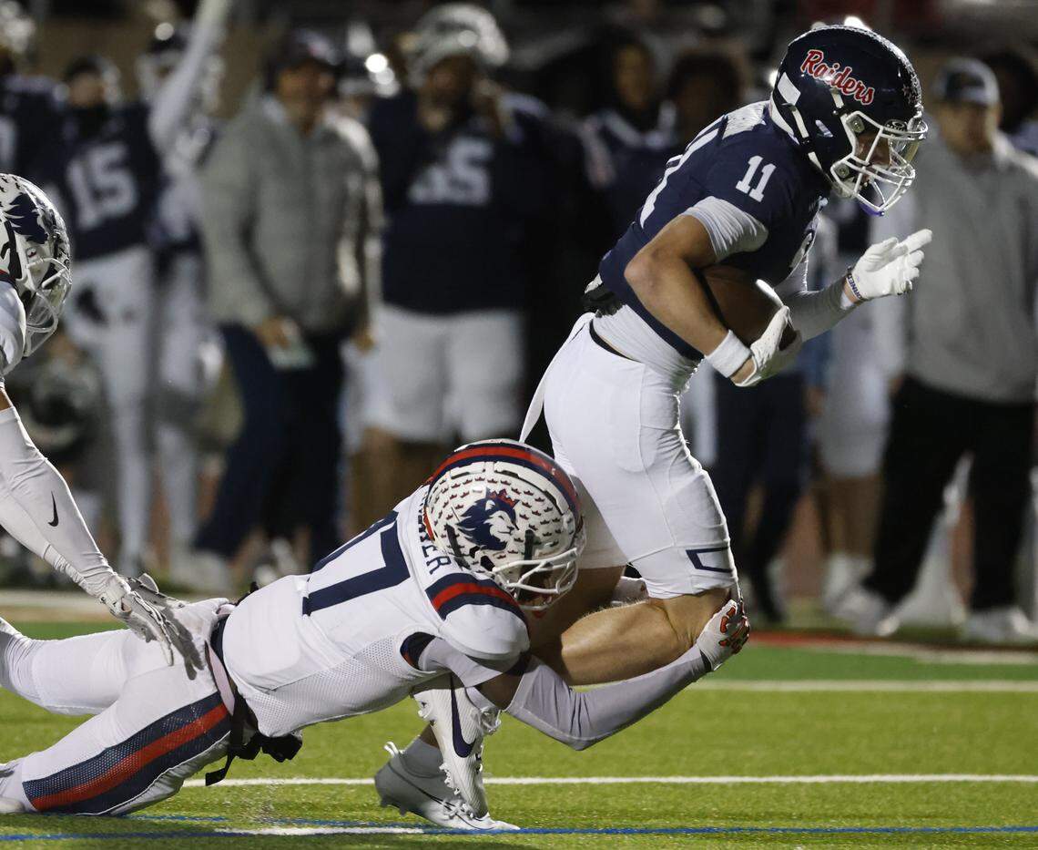 Richland defensive back Jaxson Walker (17) drags Denton Ryan wide receiver Connelly Cunningham (11) from behind during the first half of a UIL Class 5A Division I Regional on Friday Nov. 28, 2025 at Buddy Echols Field in Coppell, Texas.