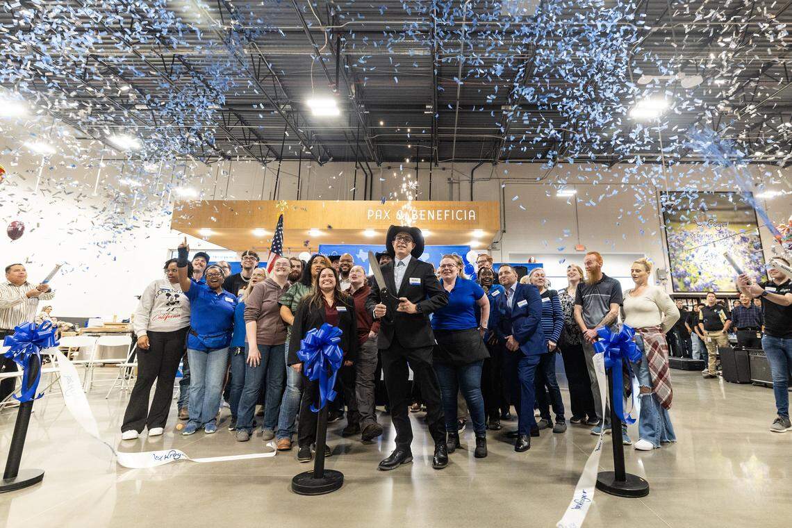Kroger Marketplace employees and representatives celebrate after the ribbon cutting at the new supermarket located in Bonds Ranch near Fort Worth.