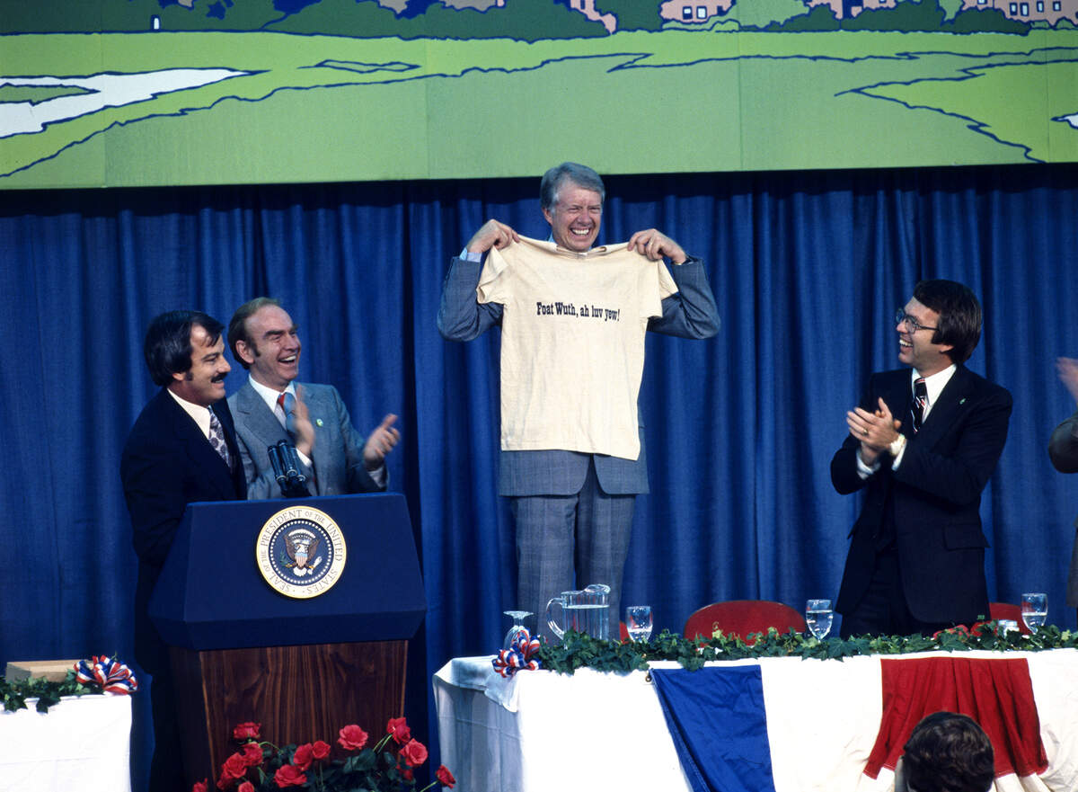 President Jimmy Carter, during a visit to Fort Worth in June 1978, received a T-shirt from Star-Telegram executive editor Jack Tinsley, left, that read “Foat Wuth, Ah Luv Yew!” He is joined by House Majority Leader Jim Wright, second from left, who was from Fort Worth, and Fort Worth Mayor Hugh Parmer, right. Willis Knight]