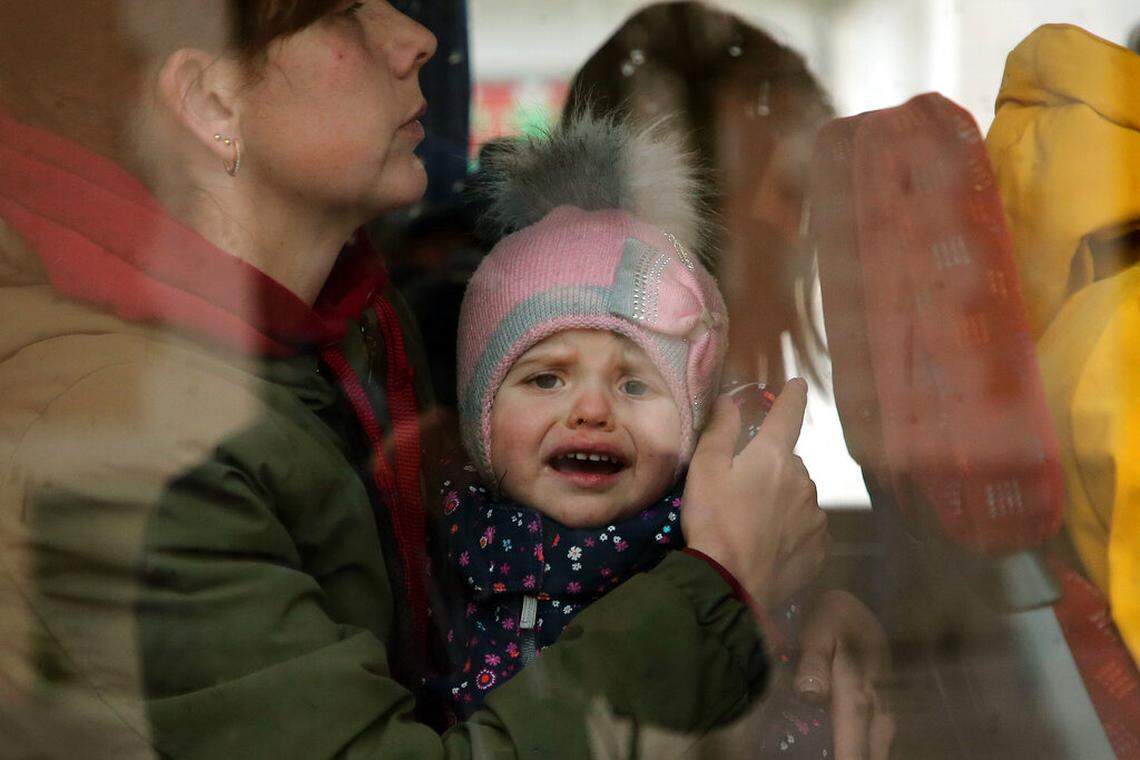 Ukrainian refugees board a bus after arriving at Hendaye, France, on Wednesday, March 9. About 200 refugees are arriving in the Atlantic coast town where local authorities are greeting them in the train station and offering them temporary lodging. They are among 2 million people, mostly women and children, who have fled fighting in Ukraine since Russia’s invasion two weeks ago.
