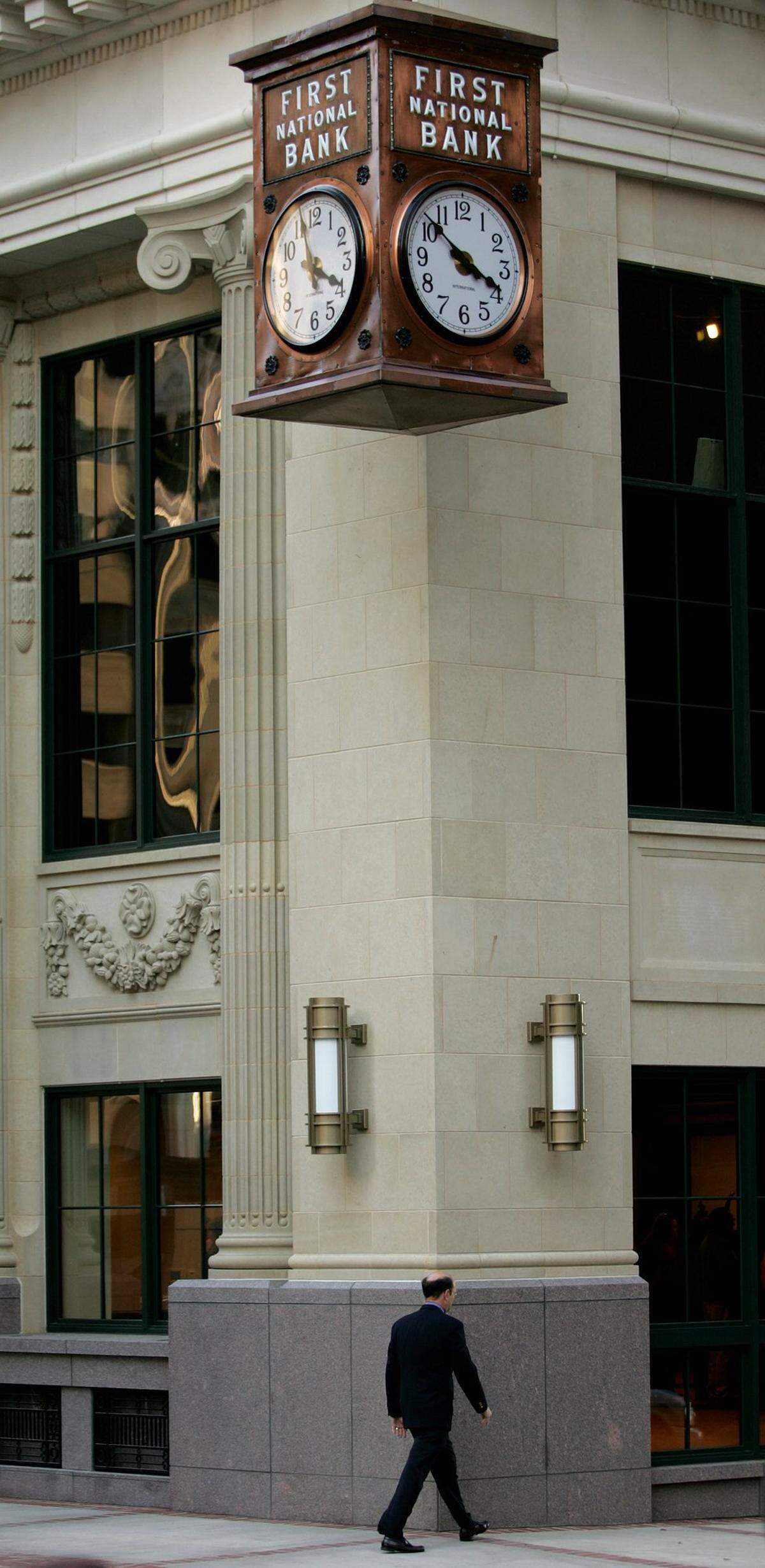 A man walks beneath the restored clock where a rededication of the Baker Building was held Thursday November 3, 2005 in Fort Worth, Texas. The Baker Building in downtown Fort Worth, Texas has been renamed the Bob R. Simpson Building.