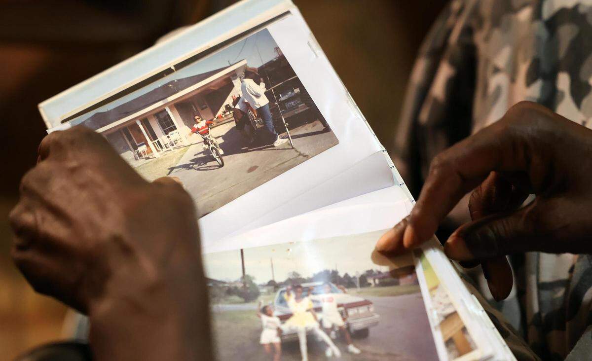 Willie Miller flips to photos of his son, Robert Miller, as a child while looking through photo albums in his Fort Worth home in July. Willie Miller said his son sometimes stayed with him but often refused, preferring to live on the streets or shelter.