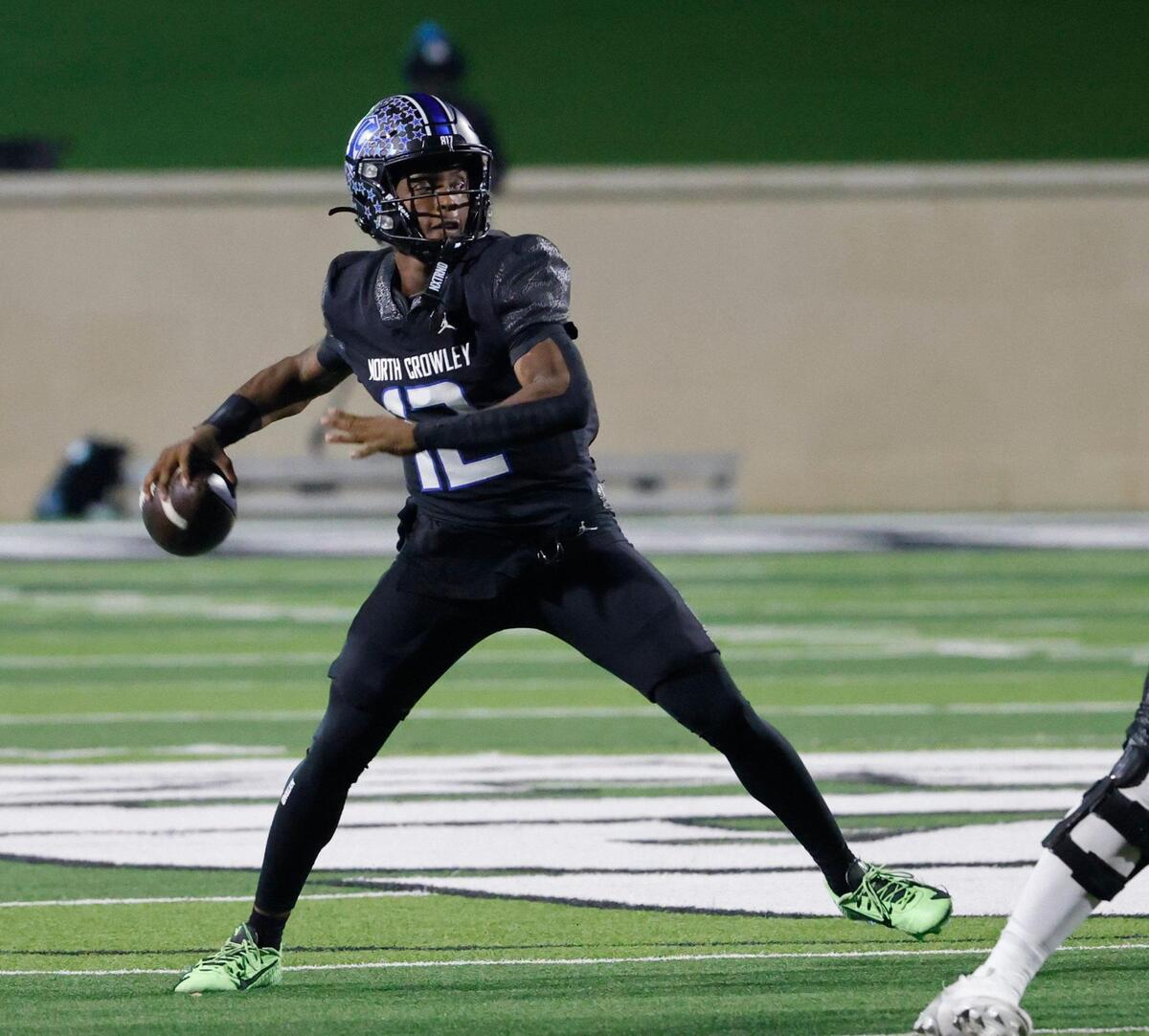 North Crowley quarterback Chris Jimerson (12) tosses a touchdown pass during a UIL Class 6A D1 Area Round football playoff football game at Crowley ISD Multi-Purpose Stadium in Fort Worth, Texas, Friday, Nov. 22, 2024.