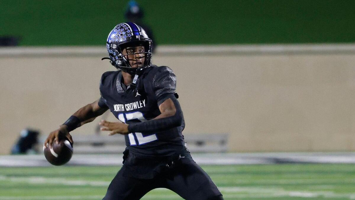 North Crowley quarterback Chris Jimerson (12) tosses a touchdown pass during a UIL Class 6A D1 Area Round football playoff football game at Crowley ISD Multi-Purpose Stadium in Fort Worth, Texas, Friday, Nov. 22, 2024.