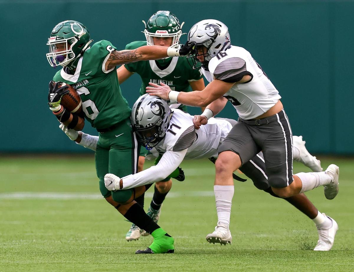Arlington running back BJ Rogers (6) tries to break a tackle from Denton Guyer linebacker Carson Parham (11) during the first half of the 6A Division II Area round high school football playoffs, December 19, 2020, played at Globe Life Park in Arlington, Tx. (Steve Nurenberg Special to the Star-Telegram)