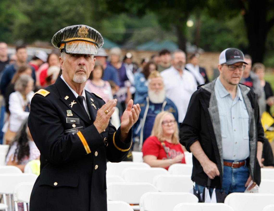 A retired U.S. Army member applauds the recognition of military members both active and retired during the 96th Fort Worth Memorial Day Service at Mount Olivet Cemetery in Fort Worth, Texas, Monday, May 26, 2025.