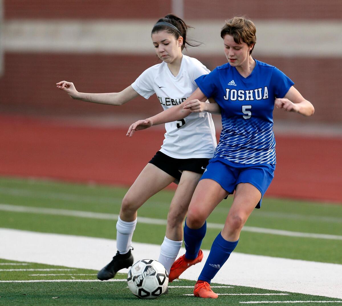 Cleburne’s Cadence Tucker (5) and Joshua’s Abigale Miller (5) battle for the ball during a District 14-5A high school soccer game at Joshua High School in Joshua, Texas, Monday, March 08, 2021. The girls played to a scoreless game. (Special to the Star-Telegram Bob Booth)