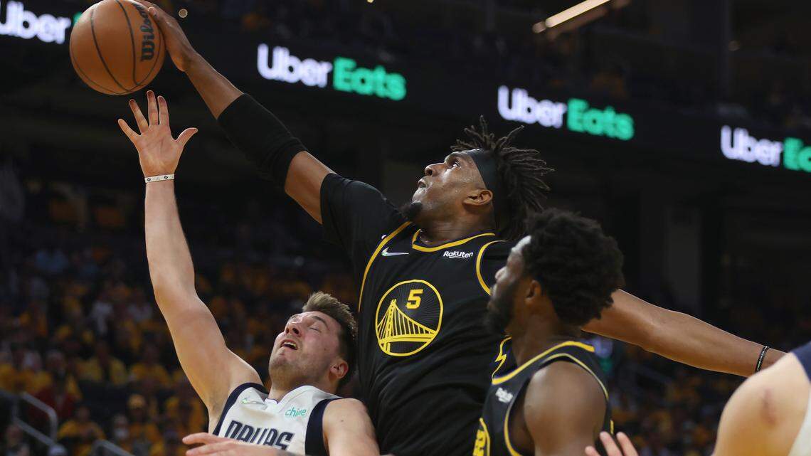 Luka Doncic, left, has his shot swatted away by Golden State Warriors center Kevon Looney in the first half of Wednesday’s Game 1 in San Francisco.