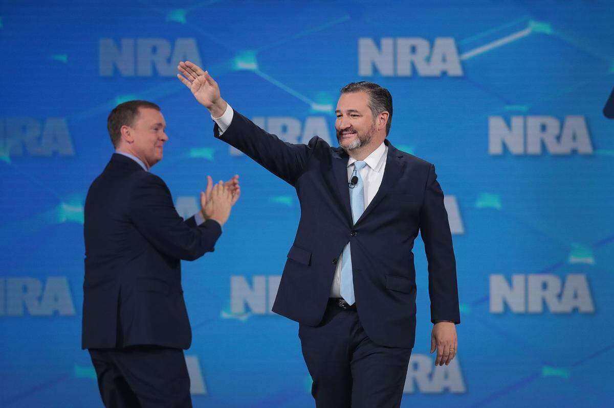 Sen. Ted Cruz (right) takes the stage during the 148th NRA Annual Meetings & Exhibits on April 26, 2019, in Indianapolis.