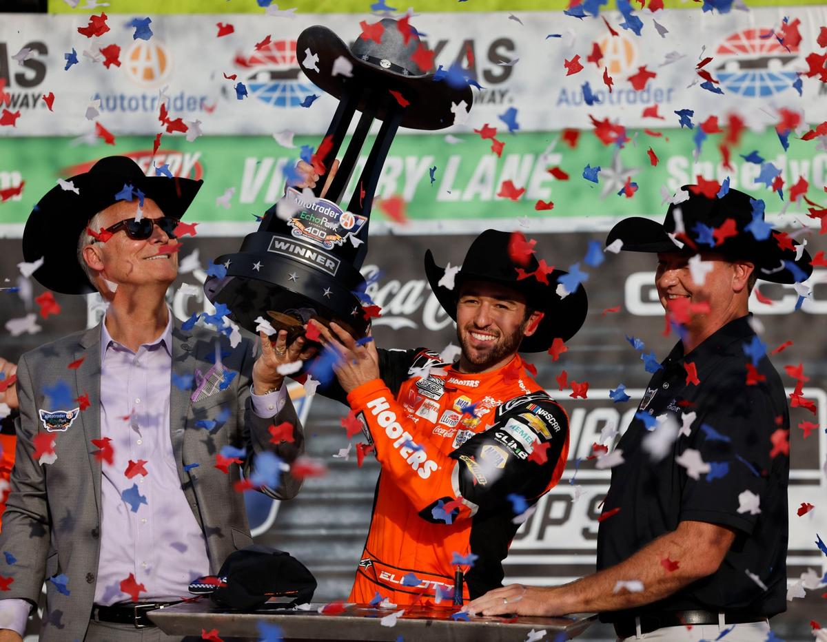 Chase Elliott (9) hoists the trophy after winning the Auto Trader Echo Park 400 at Texas Motor Speedway in Fort Worth, Texas, April 14, 2024. Kyle Larson won stage 1. (Special to the Star-Telegram/Bob Booth)
