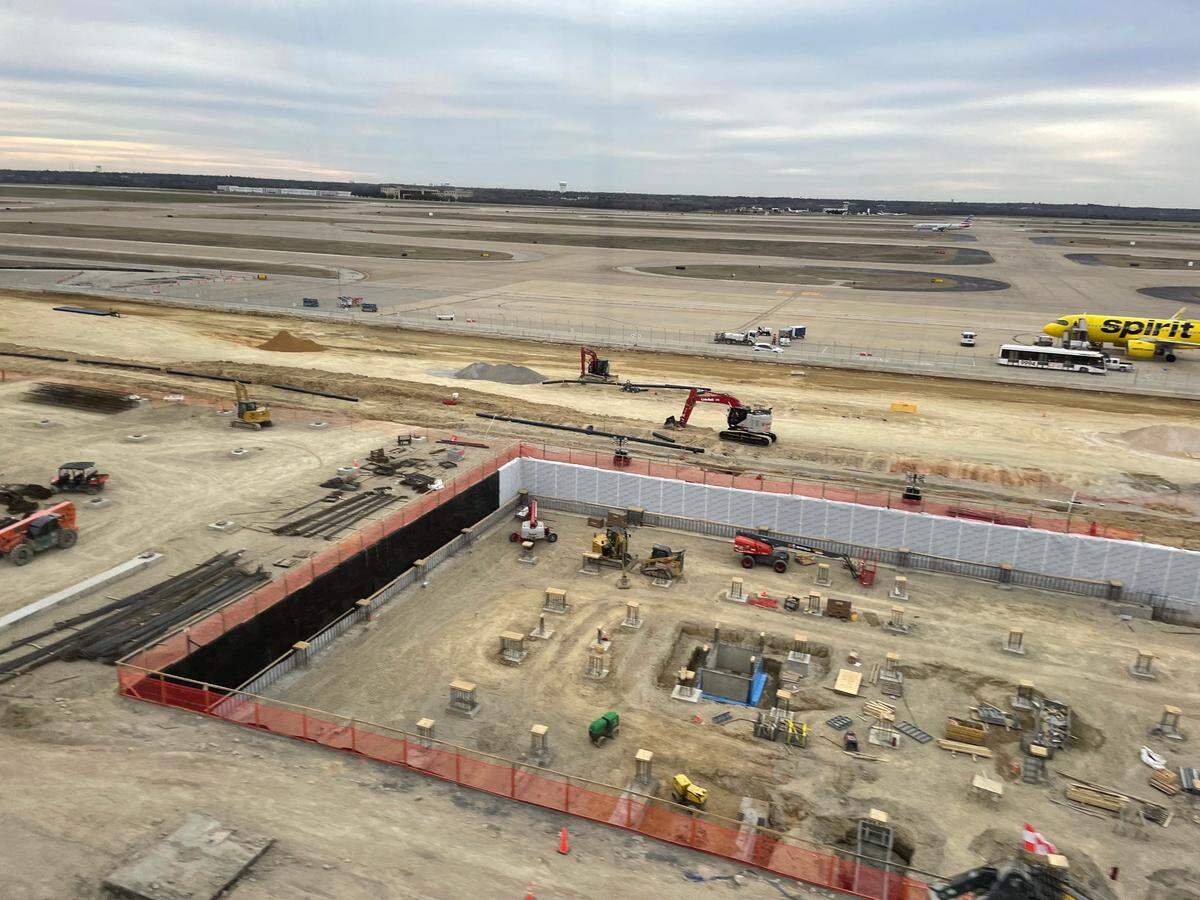 Photo of the construction site of Terminal F at DFW airport seen from the Skylink train.