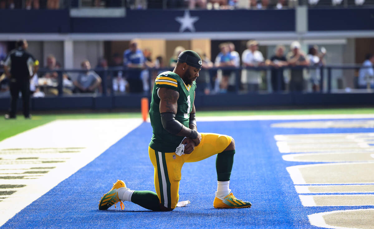 Green Bay Packers defensive end Micah Parsons takes a knee before the start of the game Sunday.