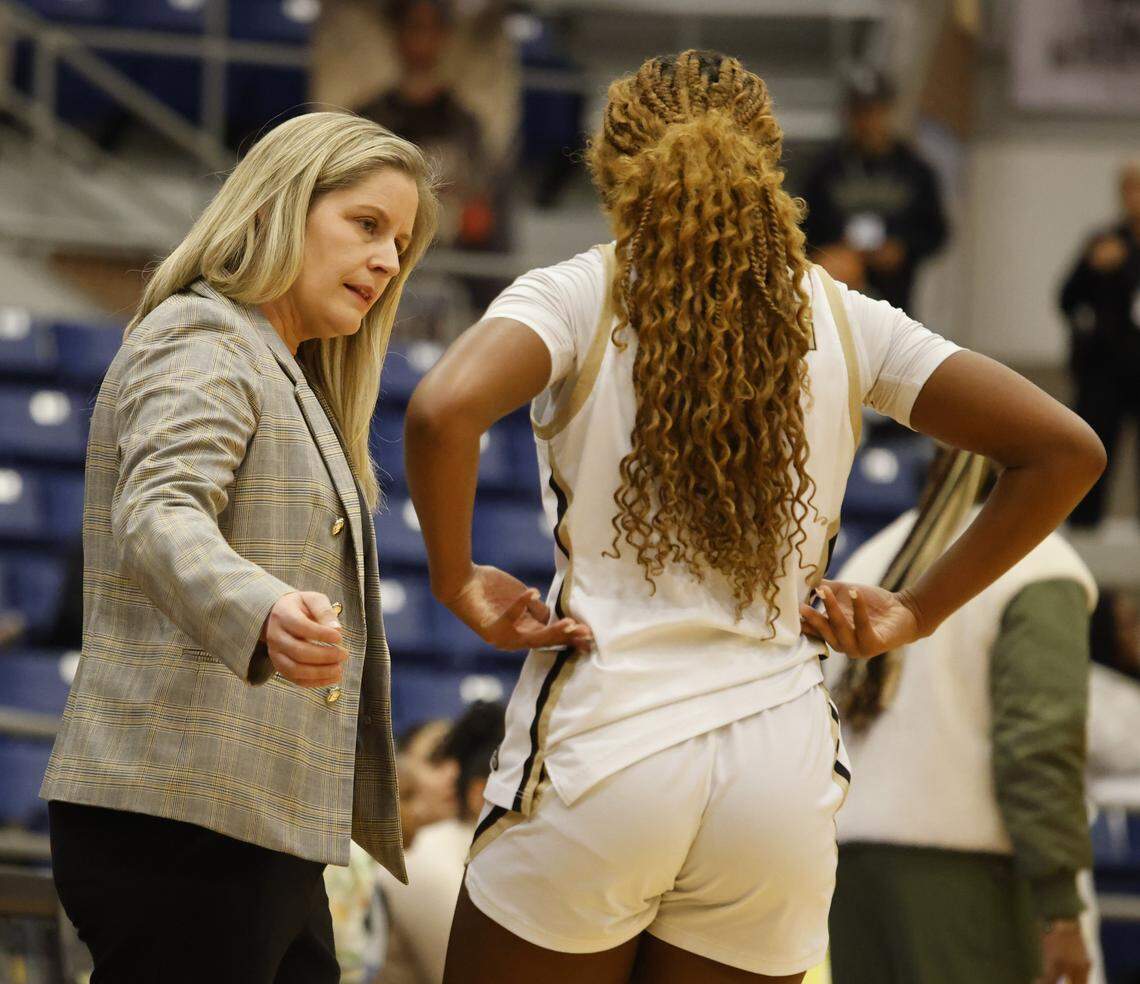 Mansfield head coach Brooke Brittain talks to shooting guard Jayda Bryd (11) on the side lines during the first half of a UIL girls basketball game between North Crowley and Mansfield at Mansfield High School in Mansfield, Texas, Tuesday Jan. 20, 2026