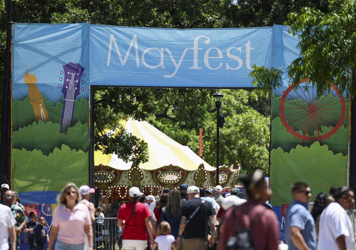 People gather at Mayfest, a community celebration at Trinity Park, on Saturday, May 2, 2026, in Fort Worth, Texas. The festival, which happens the first weekend of May, brings live music, art, carnival rides and more to Trinity Park.