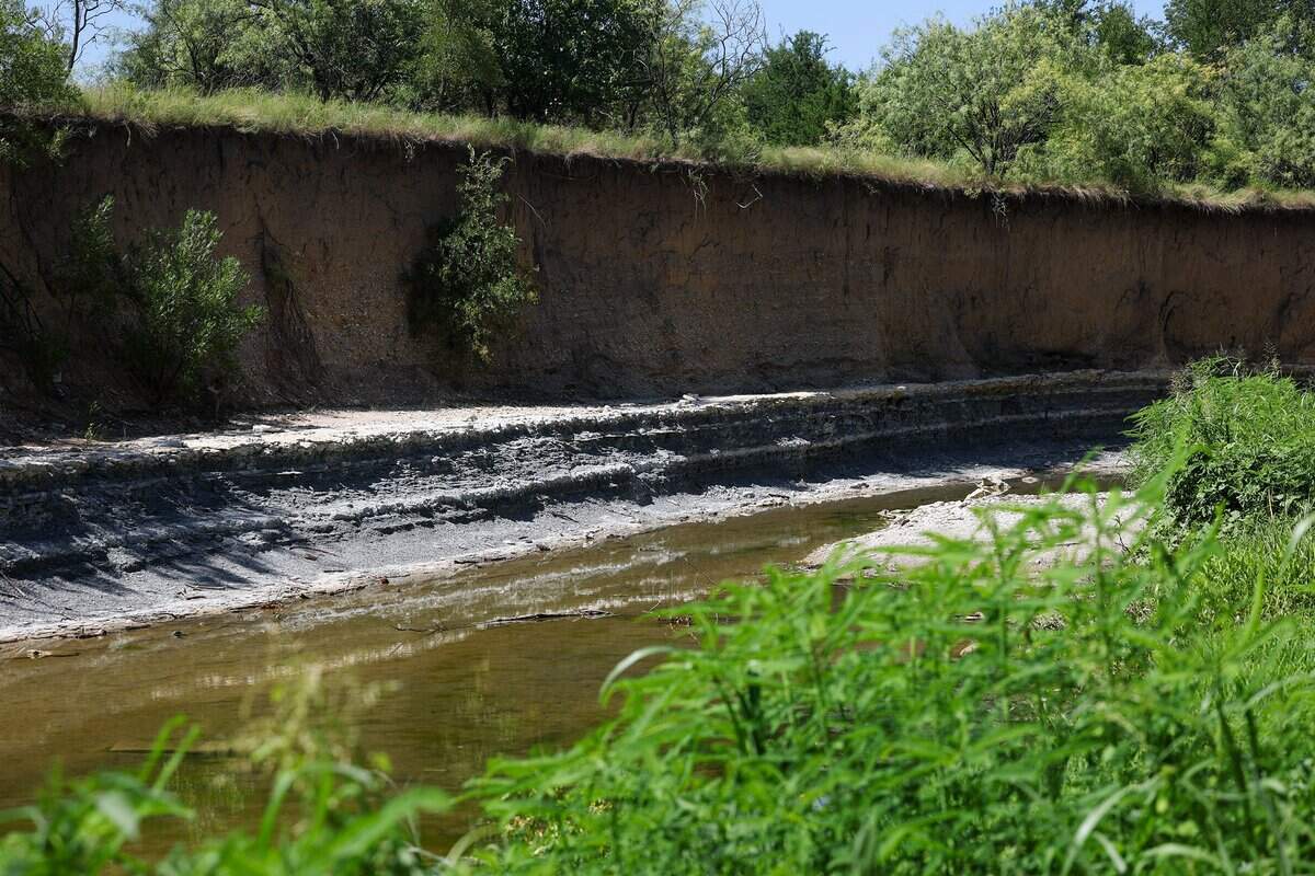 Mary's Creek runs left to right with a high bluff rising along its edge.