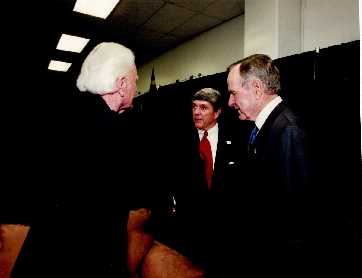 Evangelist Billy Graham, left, with former President George H.W. Bush and U.S. Rep. Roger Williams before a 2002 crusade in Texas Stadium.