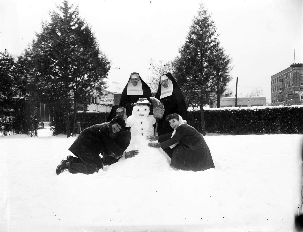 Jan. 28, 1948: “ Nuns with children in snow building a snowman. The children are Charles Carter and Barbara Ann Bear; nuns are (kneeling) Mary Michael Dittre and (left) Cecilia Frances O’Rourke (nun on right unknown) at Saint Ignatius Academy, Fort Worth, Texas.”