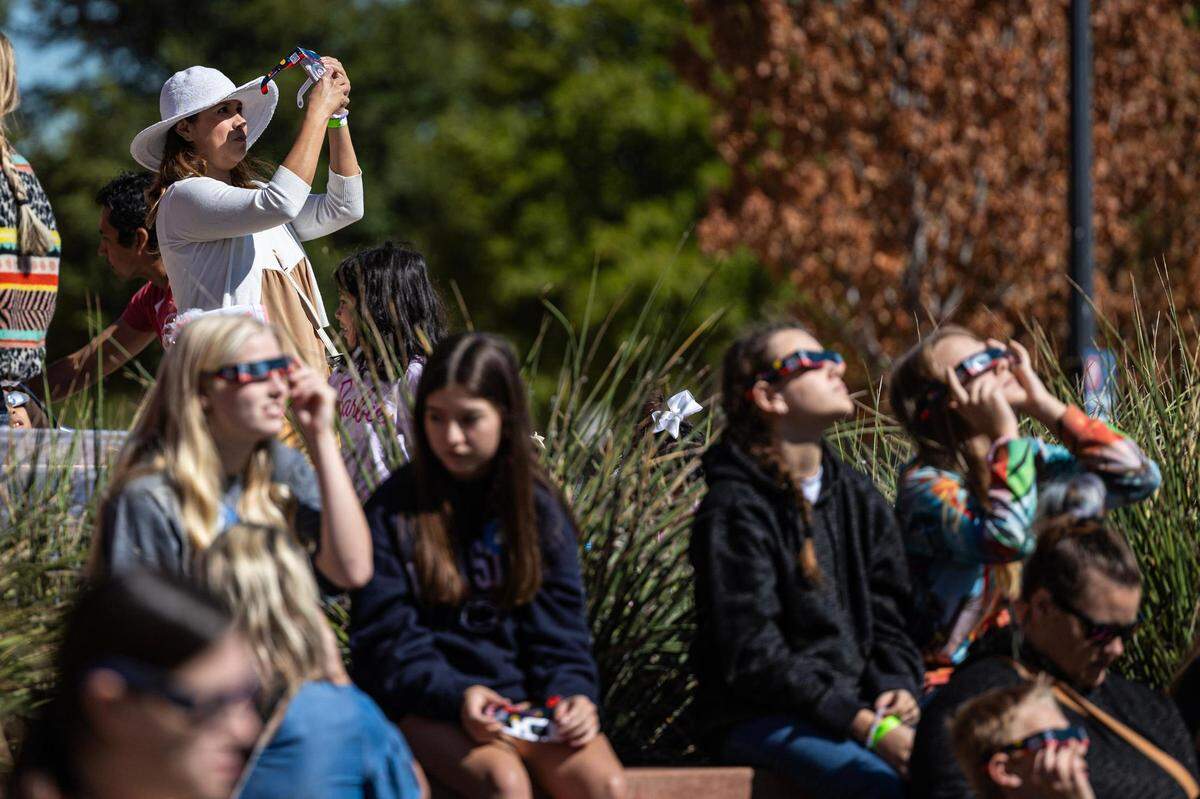Spectators put on the solar goggles to view the eclipse during the Annular Solar Eclipse event at the Fort Worth Museum of Science & History on Saturday, Oct. 14, 2023.