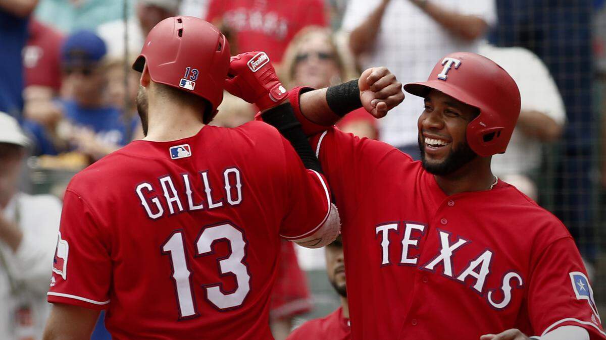 Elvis Andrus congratulates Joey Gallo after he connected for one of his two homers Wednesday in the Rangers’ win over the Mariners.