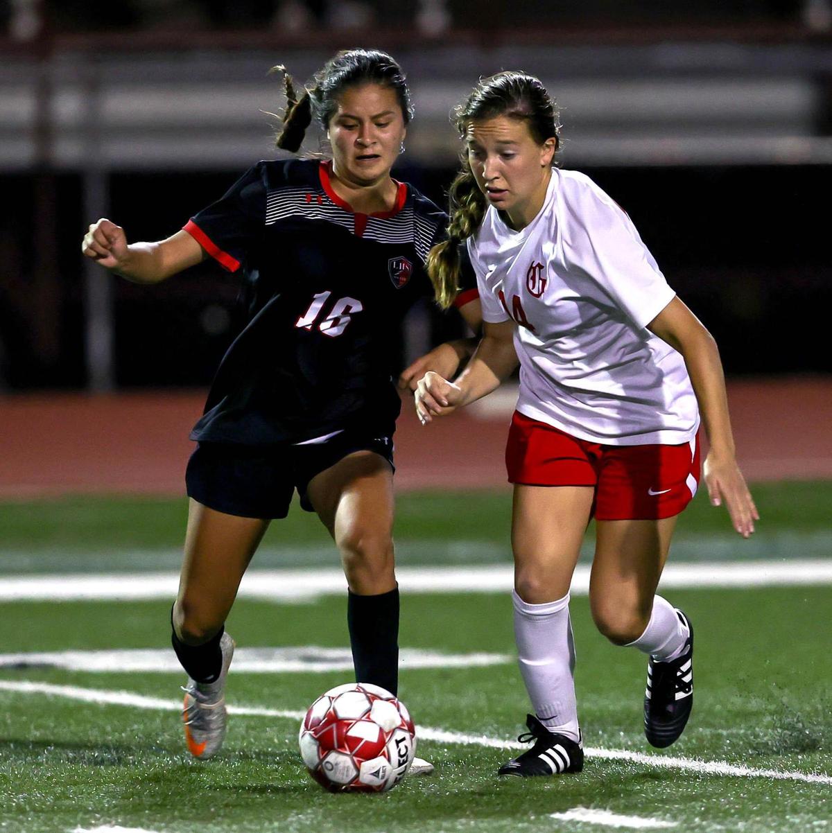 Mansfield Legacy’s Yareli Mendoza (16) and Grapevine’s Theresa McCullough (14) go for a loose ball during the second half of the 5A Region 1 area round girls soccer playoffs played on March 30 2021, at Cravens Field in Arlington, TX. (Steve Nurenberg Special to the Star-Telegram)
